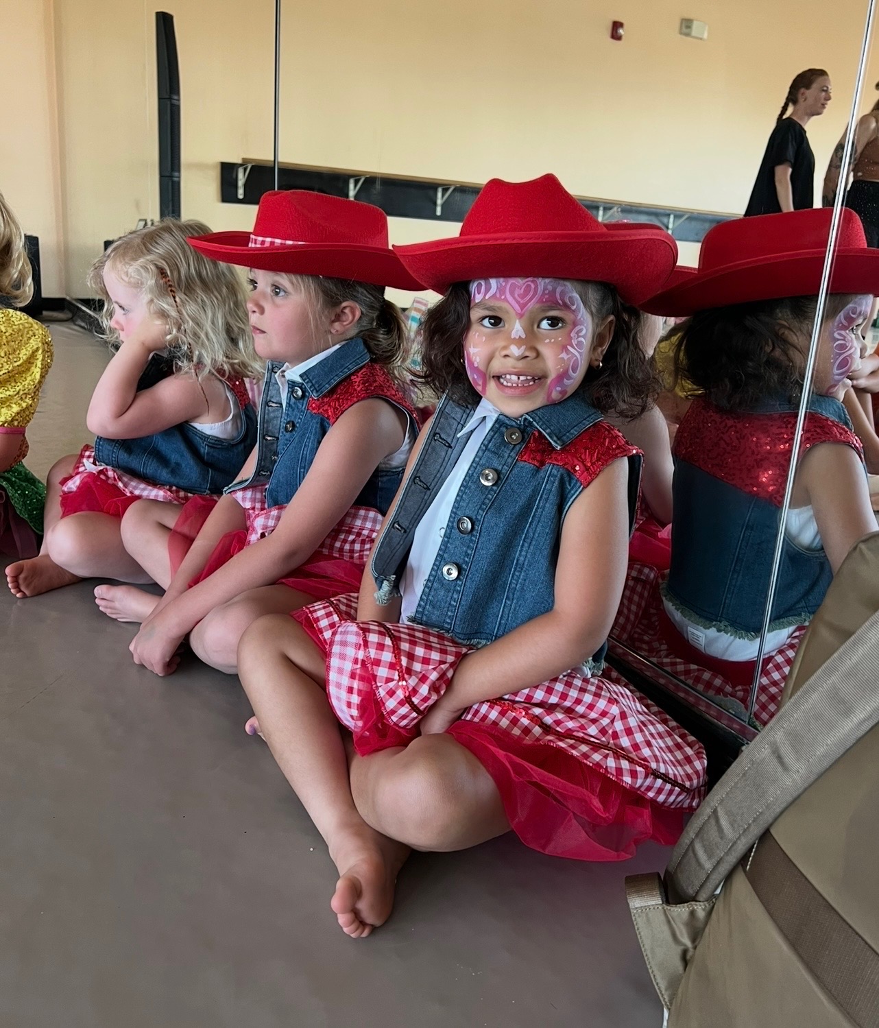 Mini dancer in costume waiting to perform