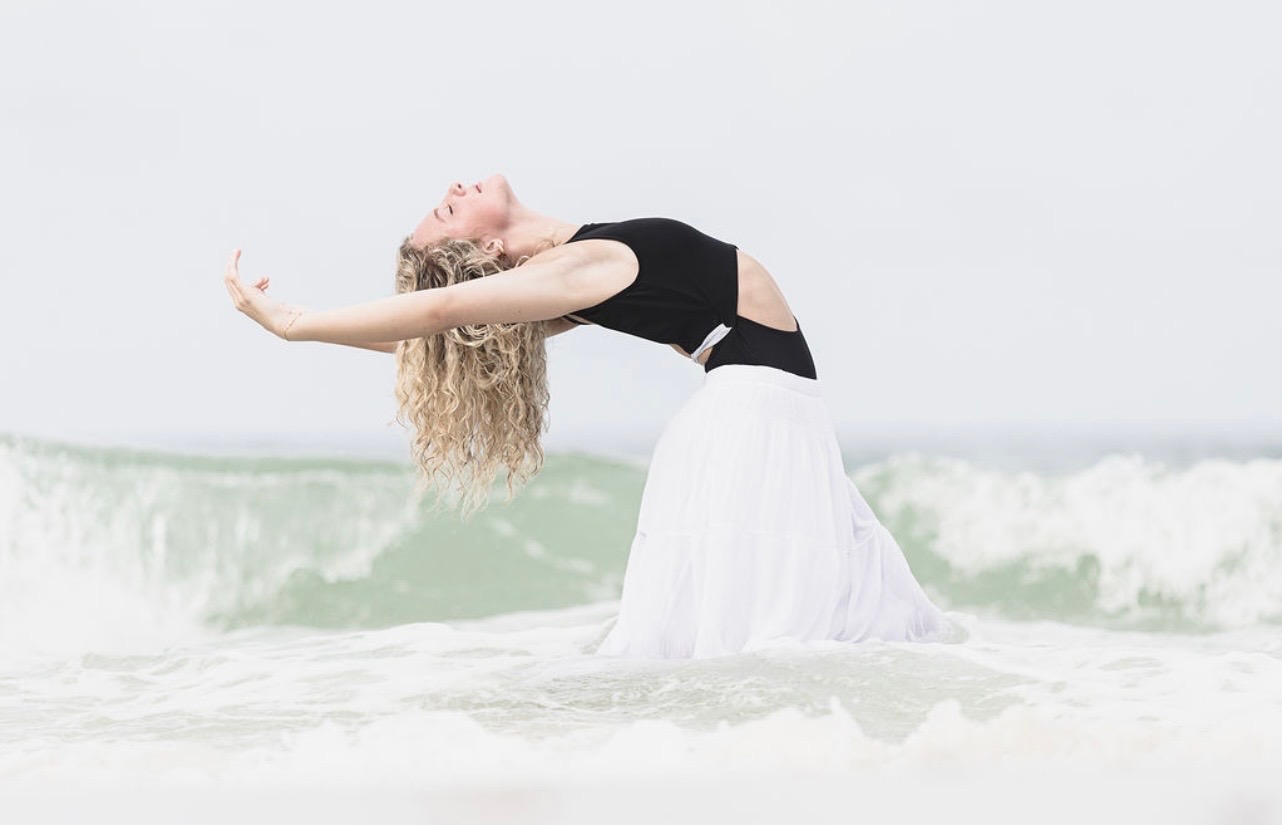 STDA dancer arching back in the ocean surf